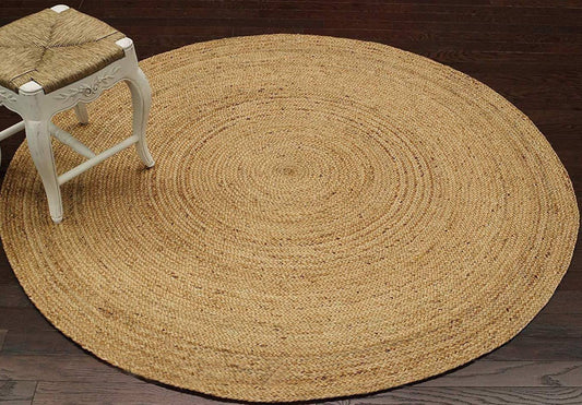 Round handwoven jute rug in a warm golden color